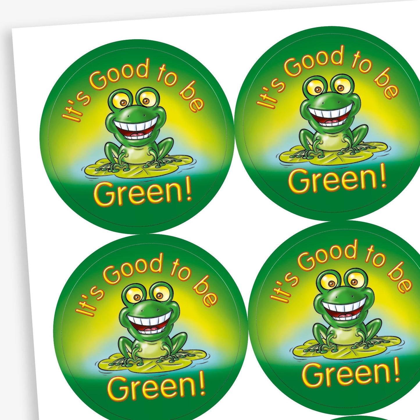 Circular stickers with a green background central is a cheerful green frog illustration with wide eyes and a big smile, sitting on a lily pad. The phrase 'IT'S GOOD TO BE GREEN' in bold yellow lettering surrounds the frog