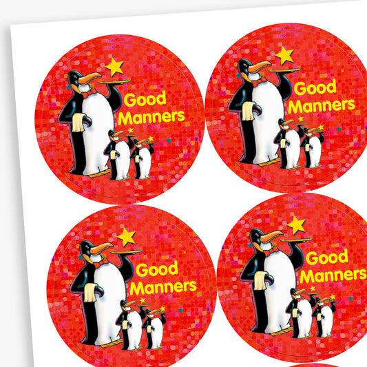 A sheet of red holographic circular reward stickers for children. Each sticker features a group of three cartoon penguins standing together, with a yellow star above them and the phrase 'Good Manners' written in yellow text.