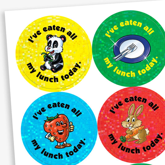 A sheet of circular reward stickers with the phrase 'I've eaten all my lunch today.' Each sticker has a colourful holographic background and features different images: a panda eating bamboo, a plate with cutlery, a smiling strawberry, and a rabbit holding a carrot.