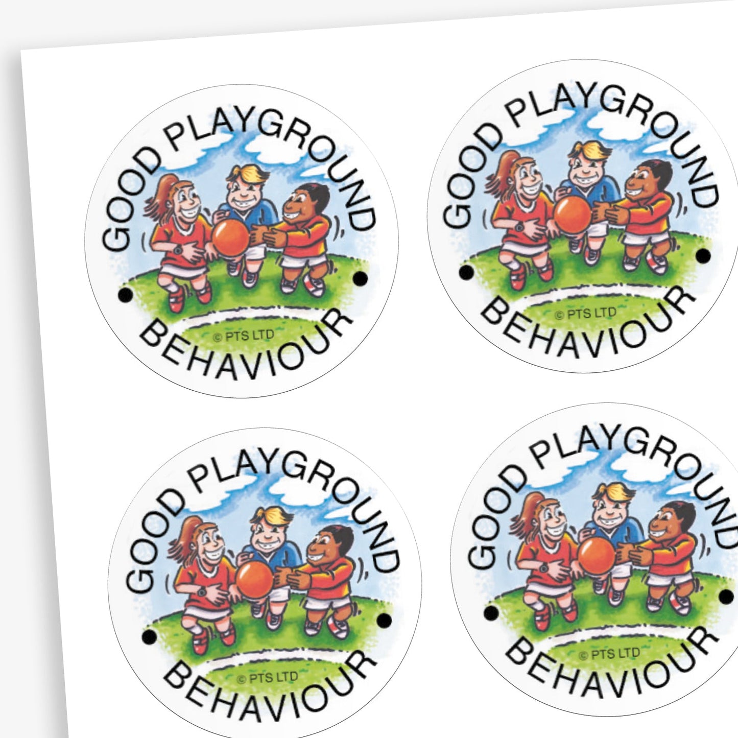 A sheet of white circular reward stickers for children. Each sticker shows a cartoon scene of three children in red sports kits playing with a ball on a grassy playground, supervised by a smiling adult. The text around the edge reads 'GOOD PLAYGROUND BEHAVIOUR' in black capital letters