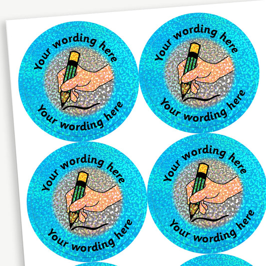 Circular reward stickers with a glittery holographic cyan border.  Each features a silver centre with a hand writing with a green pencil. Placeholder text 'Your wording here' is curved along the top and bottom edge for customisation.