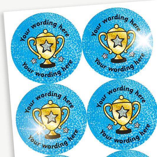 Sheet of round, holographic blue stickers, each featuring a gold trophy at the centre. Surrounding is placeholder text reading 'Your wording here' above and below, indicating customisable areas for personalised messages