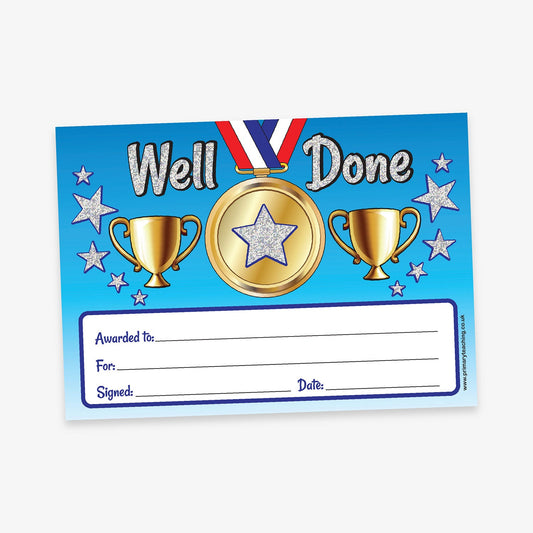 A5-sized holographic 'Well Done' certificate featuring a gold medal with 2 trophies surrounded by silver stars. The certificate includes spaces labelled 'Awarded to', 'For', 'Signed', and 'Date'.