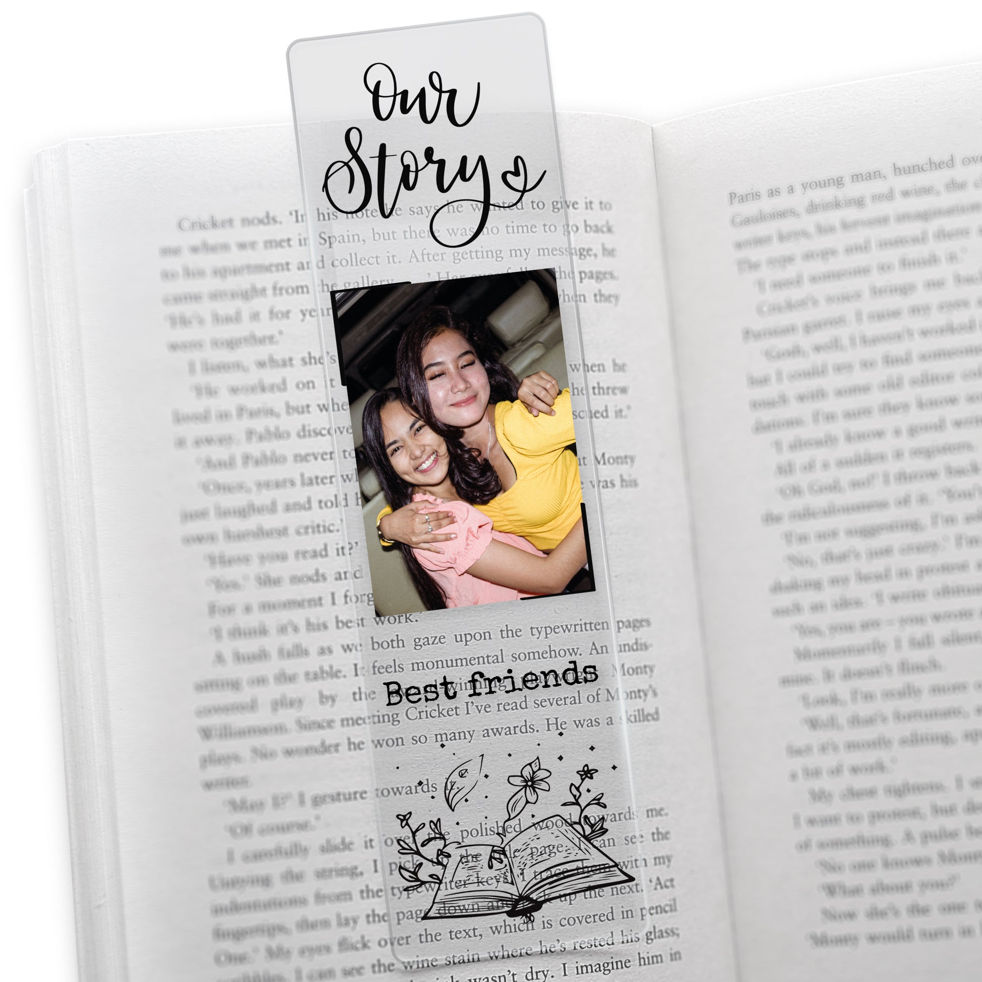 Clear acrylic friendship-themed bookmark featuring the phrase 'Our Story' at the top, a photo of two friends hugging, and the words 'Best friends' in black font above an illustrated open book with botanical elements.