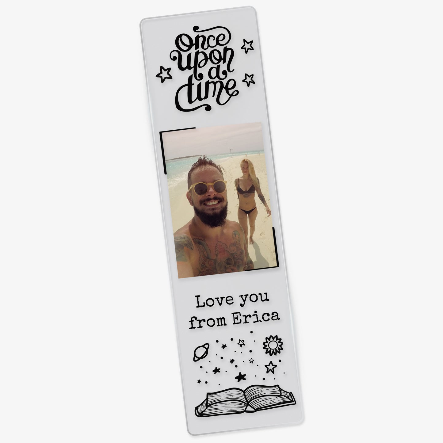 Clear acrylic relationship-themed bookmark featuring the phrase 'Once upon a time' at the top, a photo of a couple on a beach, and the words 'Love you  from Erica' in black font above an illustrated open book with solar elements.