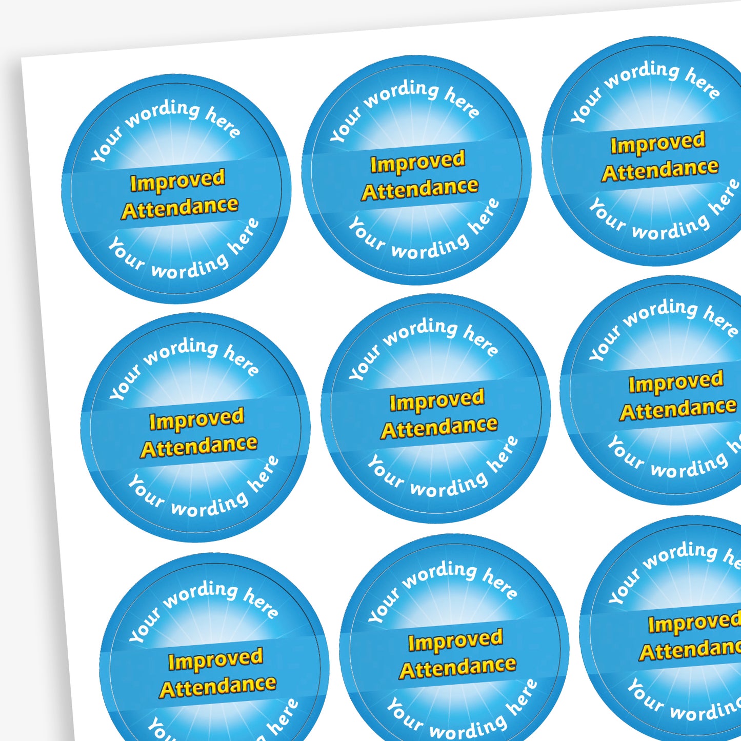 Sheet of 70 personalised 'Improved Attendance' stickers, each 25mm in diameter, featuring a light blue circular design with the text 'Improved Attendance' in bold yellow letters and space for custom wording above and below, ideal for recognising pupils' attendance improvements.