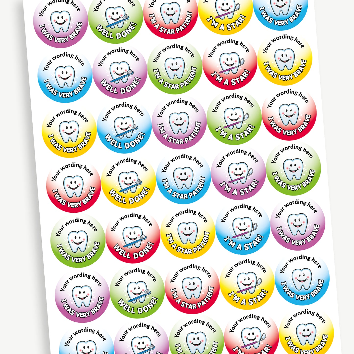 Overview of full sheet circular dental reward stickers featuring smiling cartoon teeth. Yellow sticker with the text 'I'm a Star!'. Blue sticker with 'I Was Very Brave'. Red sticker with 'Well Done!'. Green sticker with 'I'm a Star Patient'. Each sticker includes placeholder text at the top reading 'Your wording here' for customisation