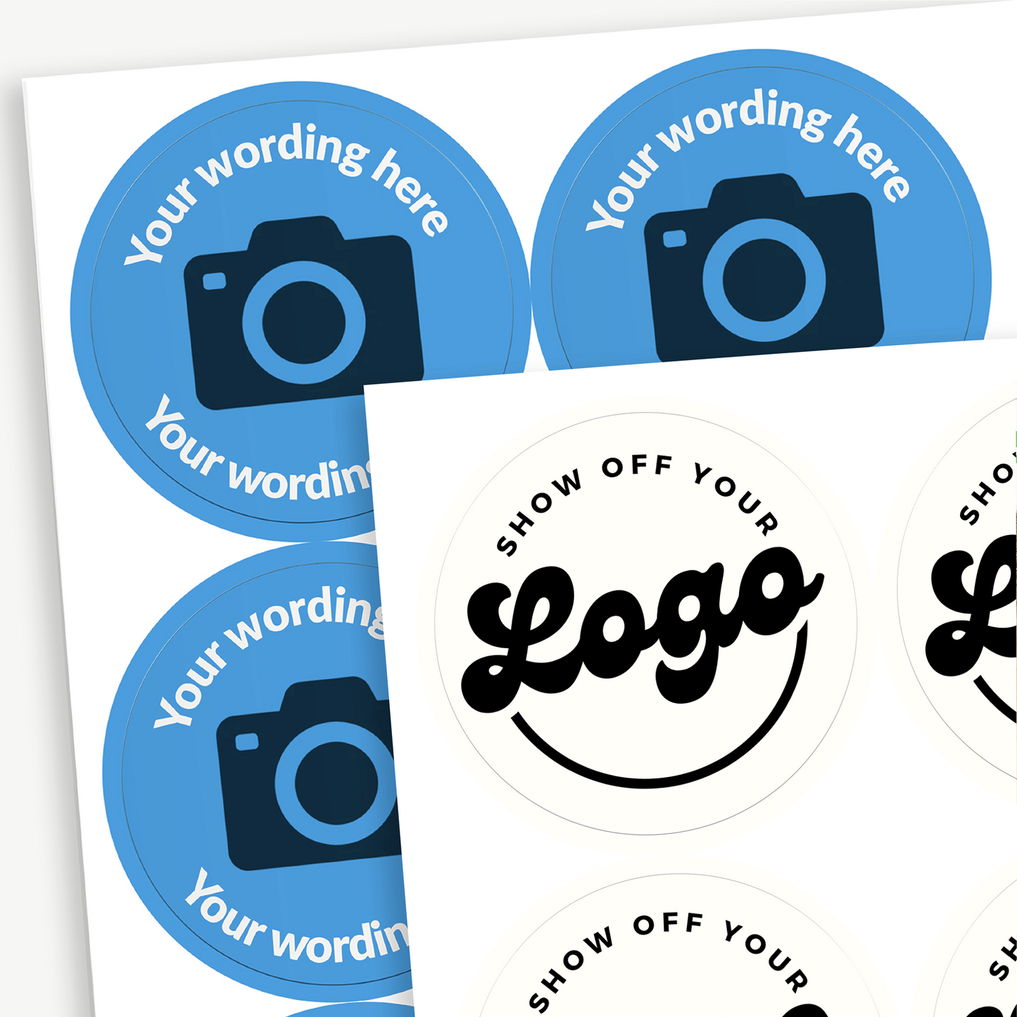 A sheet of circular stickers with a blue background and the centre has a camera icon to indicate customisation. Placeholder text 'Your wording here' arcs above and below the icon. In front is an example image with a design to 'Show off your logo'