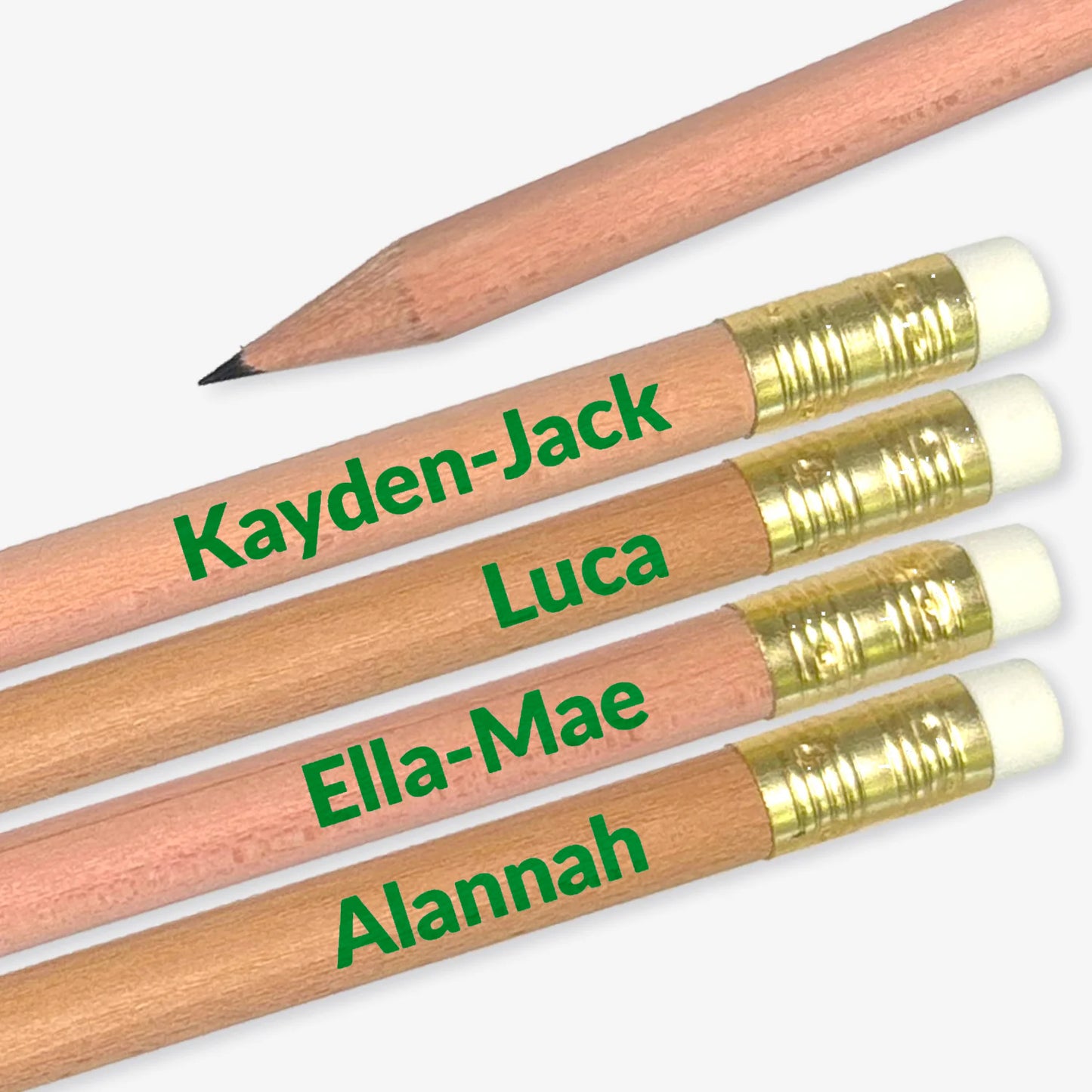 Four pencils with personalised names in green on a grey background