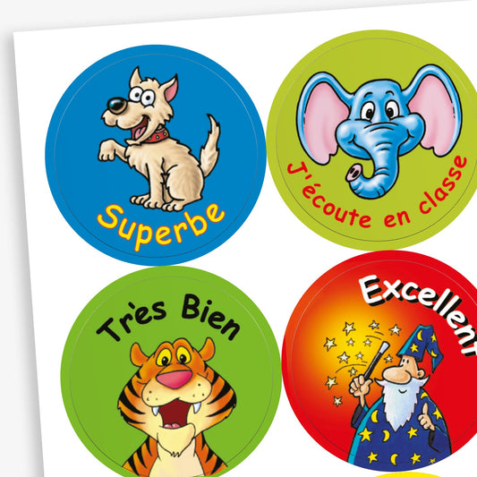 A sheet of colourful reward stickers for children, each with a cartoon character and French text. This includes: a happy dog on a blue background with the word 'Superbe', a smiling elephant on a green background with 'J'écoute en classe', a cheerful tiger on a green background with 'Très Bien' and  a wizard casting stars on a red background with 'Excellent'.