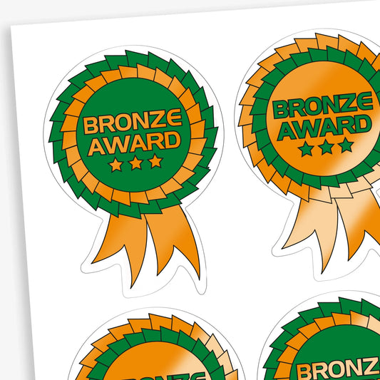 Sheet of dual colour bronze and green rosette reward stickers.  The centre of the rosette is either bronze with green text, or green with bronze text with a large 'Bronze Award' central to the design with 3 metallic stars below the text.