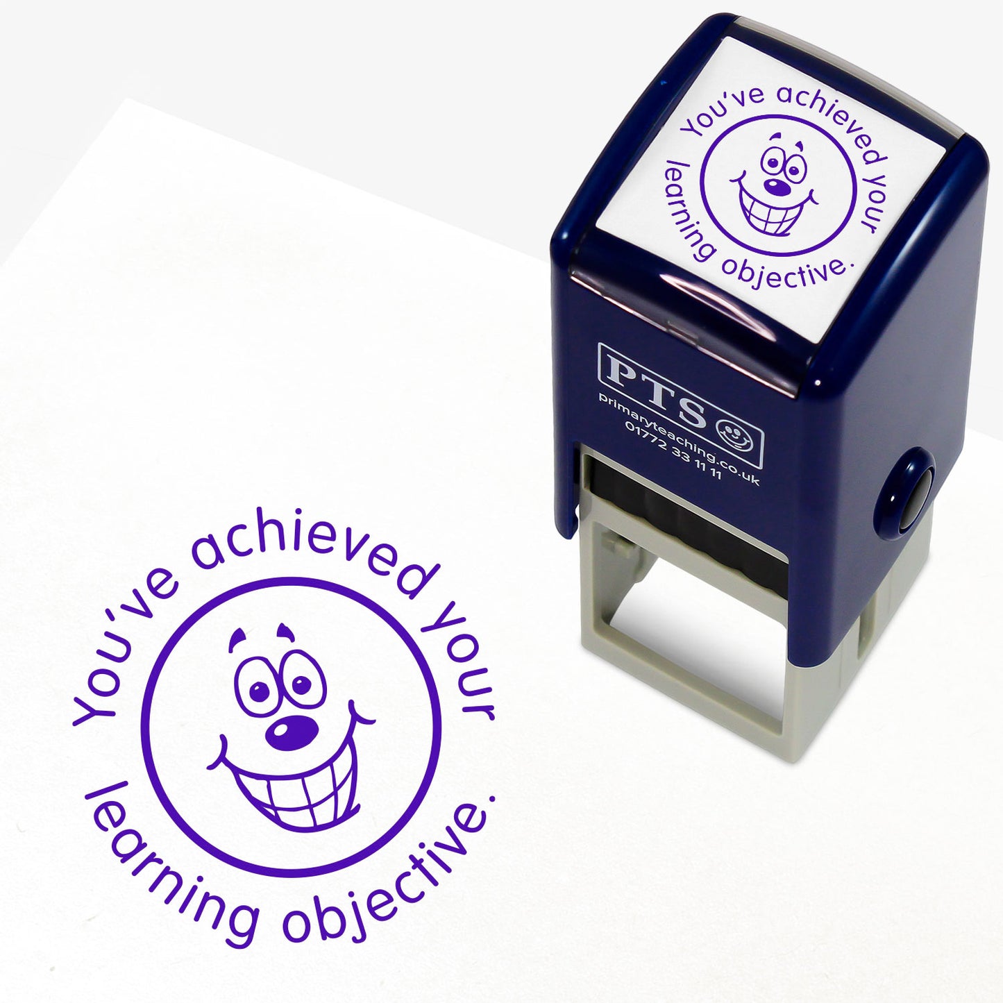 Purple 25mm pre-inked stamper featuring a grinning emoji face surrounded by the phrase 'You've achieved your learning objective'.