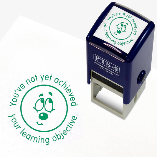Green 25mm pre-inked stamper featuring a bashful emoji face surrounded by the phrase 'You've not yet achieved your learning objective'.