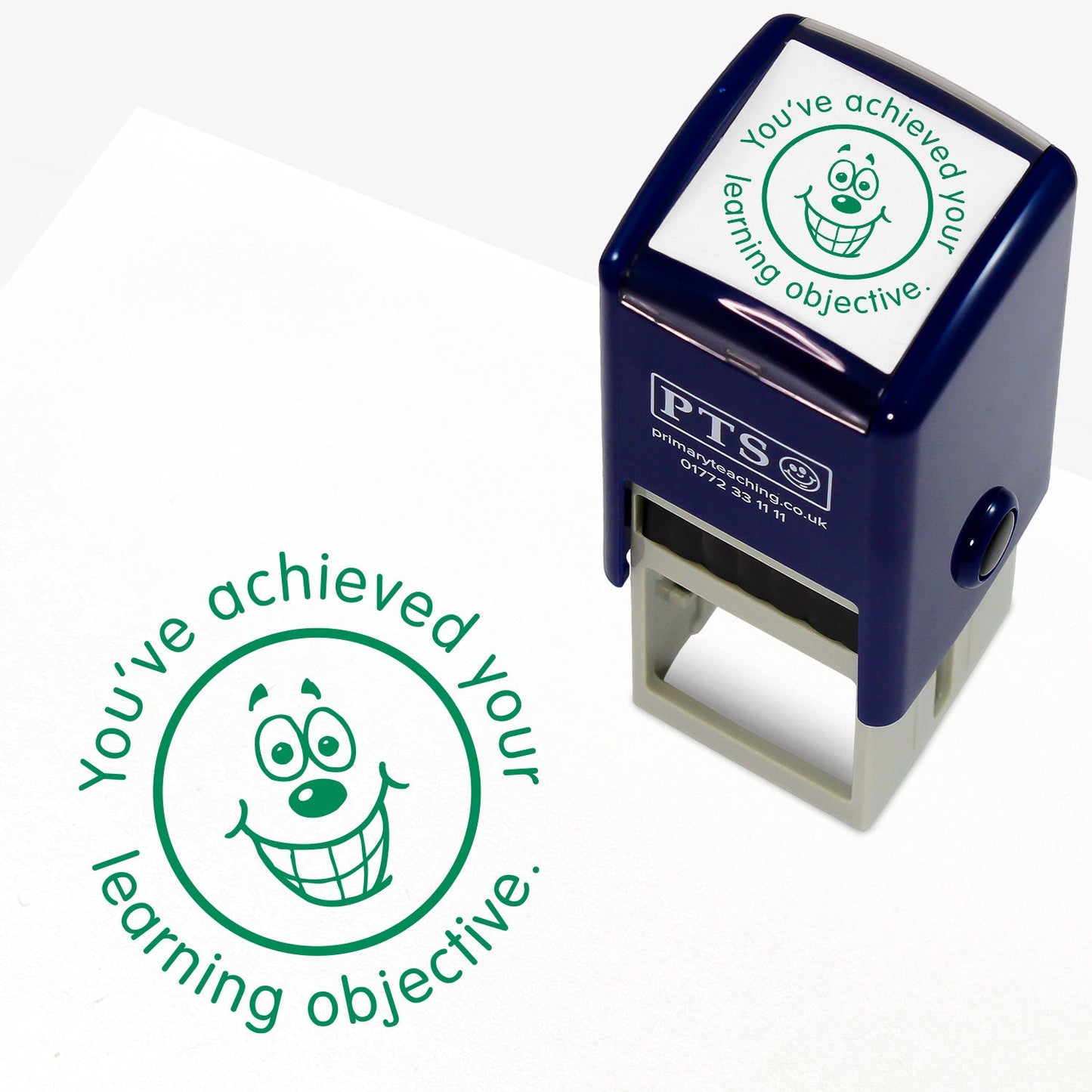 Green 25mm pre-inked stamper featuring a grinning emoji face surrounded by the phrase 'You've achieved your learning objective'.