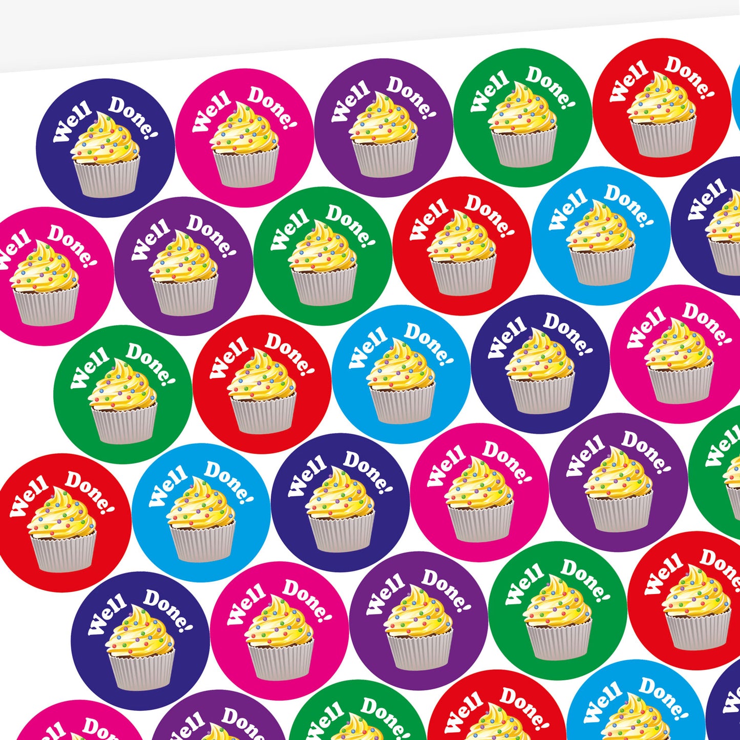 A sheet of circular, vanilla scented stickers, each with a cupcake with vanilla frosting as the main image below the phrase 'Well Done!'. Colourful backgrounds of blue, magenta and green are shown.