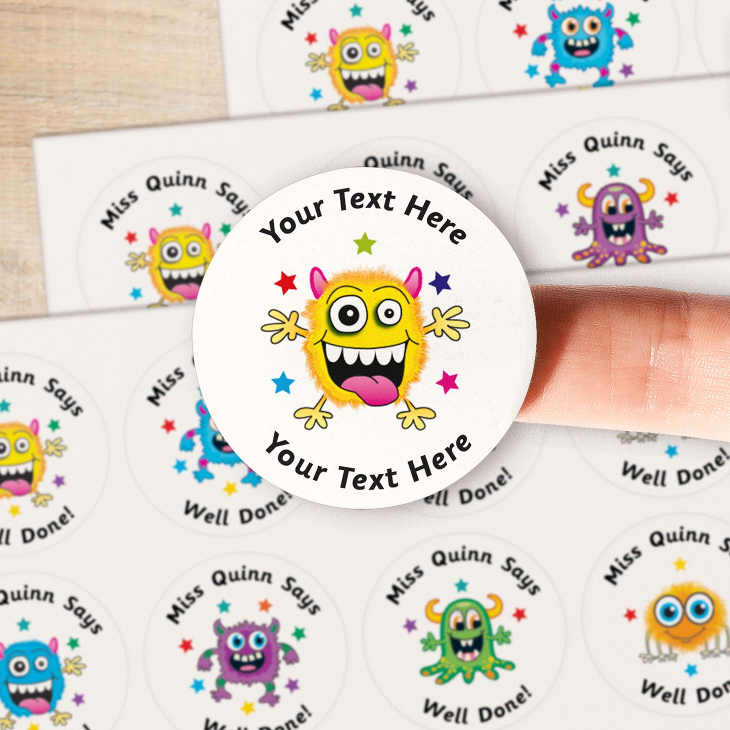 A close up image of a monster on a sticker. Text around the character is customisable.