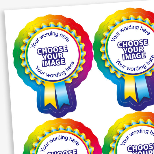 Sheet of 16 customisable rosette-shaped stickers, each measuring 44 x 58mm, featuring a rainbow-coloured ribbon border and a central white circle with placeholder text 'CHOOSE YOUR IMAGE' and 'Your wording here' above and below the central image. Designed for personalisation with choice of colour, images and text