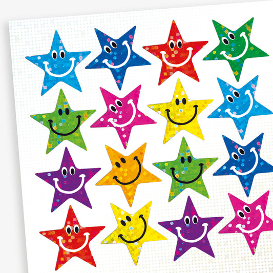 A sheet of colourful star shaped smiley face stickers with a holographic finish. Each sticker features a cheerful smiling face in different colours including blue, green, red, silver, purple and yellow.