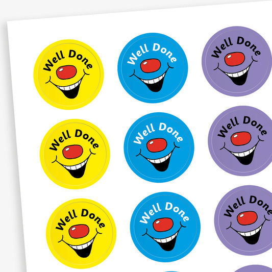 A sheet of colourful circular stickers featuring 'Well Done' against brish colour backgrounds with a red nose and laughing mouth..