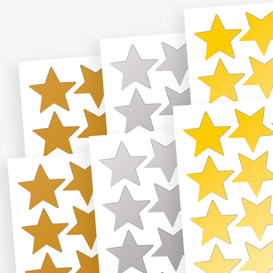 Sheets of gold, silver and bronze star shaped stickers layered upon each other.  Stickers have a metallic finish.