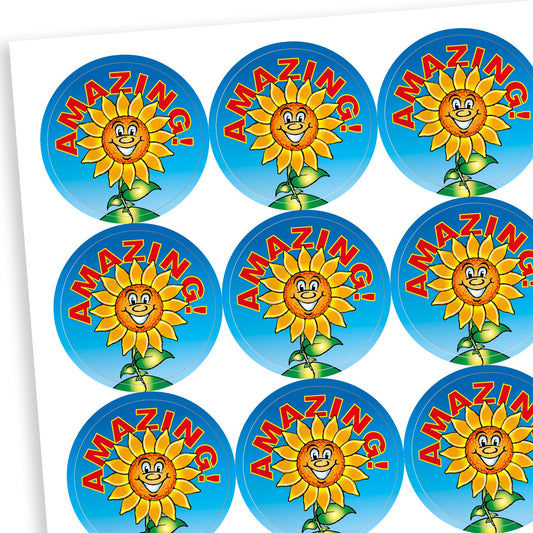 Sheet of circular stickers with a blue background and a central smiling sunflower.  Above the image is the phrase 'AMAZING!' in bold red writing with a yellow outline.
