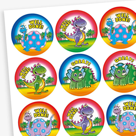 Sheet of colourful reward stickers featuring a variety of cartoon dinosaurs against a backdrop of trees with either blue, pink or red borders. Messages include 'Well Done' and 'Great'