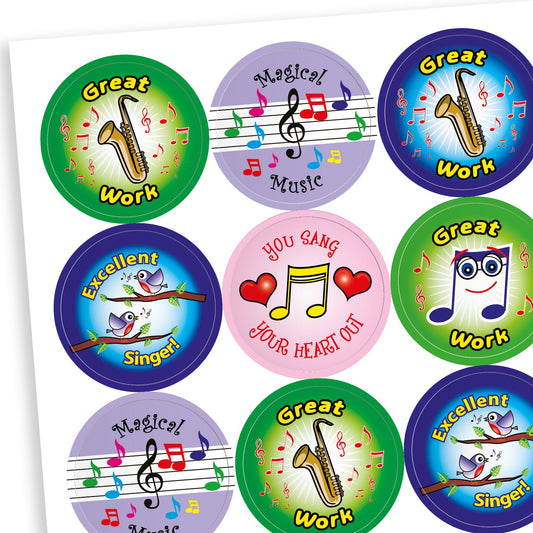 A sheet of circular music-themed reward stickers with various designs and messages. Phrases include 'Great Work' with a saxophone, 'Magical Music' with colourful notes on a stave, 'Excellent Singer!' with singing birds, 'YOU SANG YOUR HEART OUT' with a musical note and red hearts, and 'Great Work' with a smiling musical note wearing glasses. Background colours include green, blue, purple, and pink, all with bright, engaging illustrations.