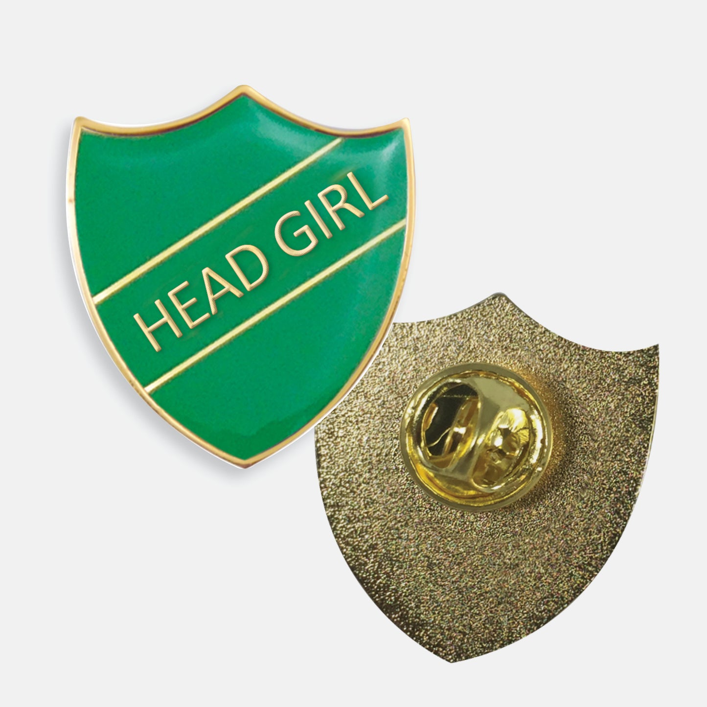 Green enamel badge in the shape of a shield with gold trim and diagonal gold line either side of the words 'HEAD GIRL' in capital letters. The reverse side shows a textured gold back with a pin fastening