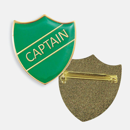 Green enamel badge in the shape of a shield with gold trim and diagonal gold line either side of the word 'CAPTAIN' in capital letters. The reverse side shows a textured gold back with a pin fastening