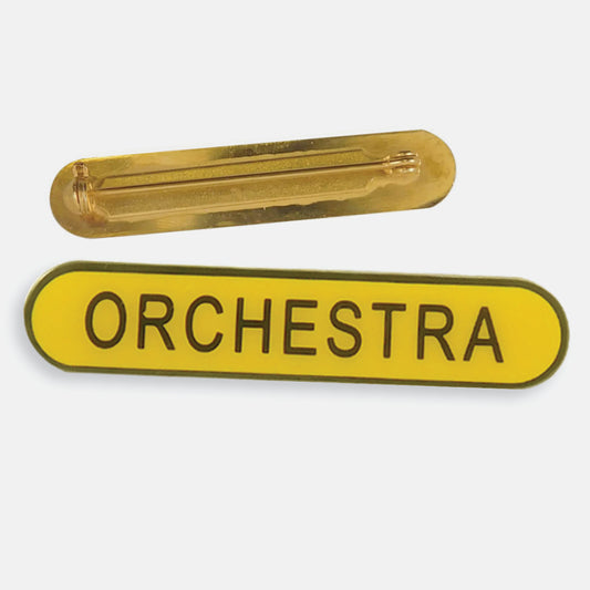 Yellow enamel badge in a long oval shape with a gold trim and the word 'ORCHESTRA' central in gold capital letters. The reverse side shows a gold back with a pin fastening