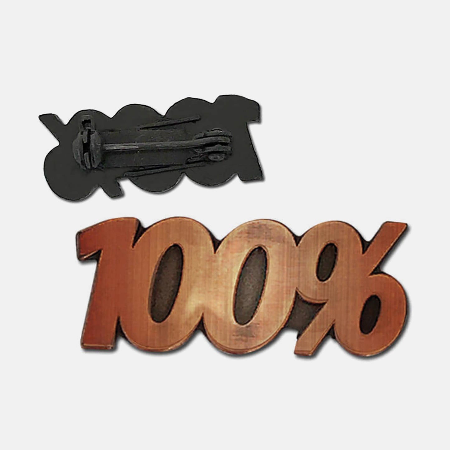 Bronze-coloured pin badge in the shape of the text '100%', with one badge showing the front and another showing the back with a pin fastening.