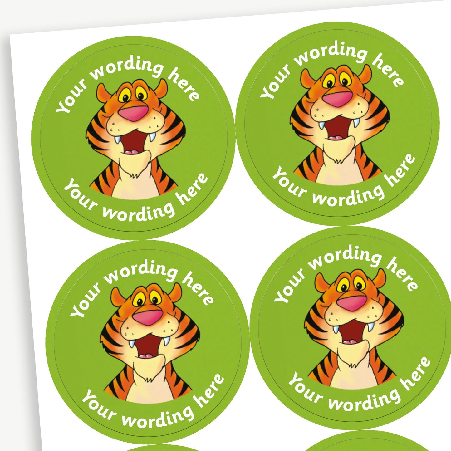 A sheet of blue circular stickers featuring a cartoon smiling tiger in the centre; curving above and below the image is space for personalisation 'Your wording here' in a clear, bold font.