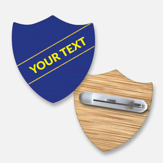 Personalised bamboo shield-shaped badge with a choice of 17 background colours.  Features a diagonal single line of customisable text in your choice of font and colour; measures approximately 34mm x 36mm and includes a pin fastening on the reverse.