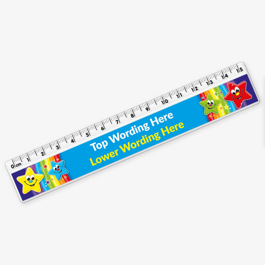 A colourful 15cm plastic ruler with a clear measuring edge marked in centimetres and millimetres. The central section features a blue background with placeholder text reading 'Top Wording Here' and 'Lower Wording Here' in yellow. Cartoon stars with smiling faces and vibrant colours—yellow, blue, green, and red—decorate both ends of the ruler.