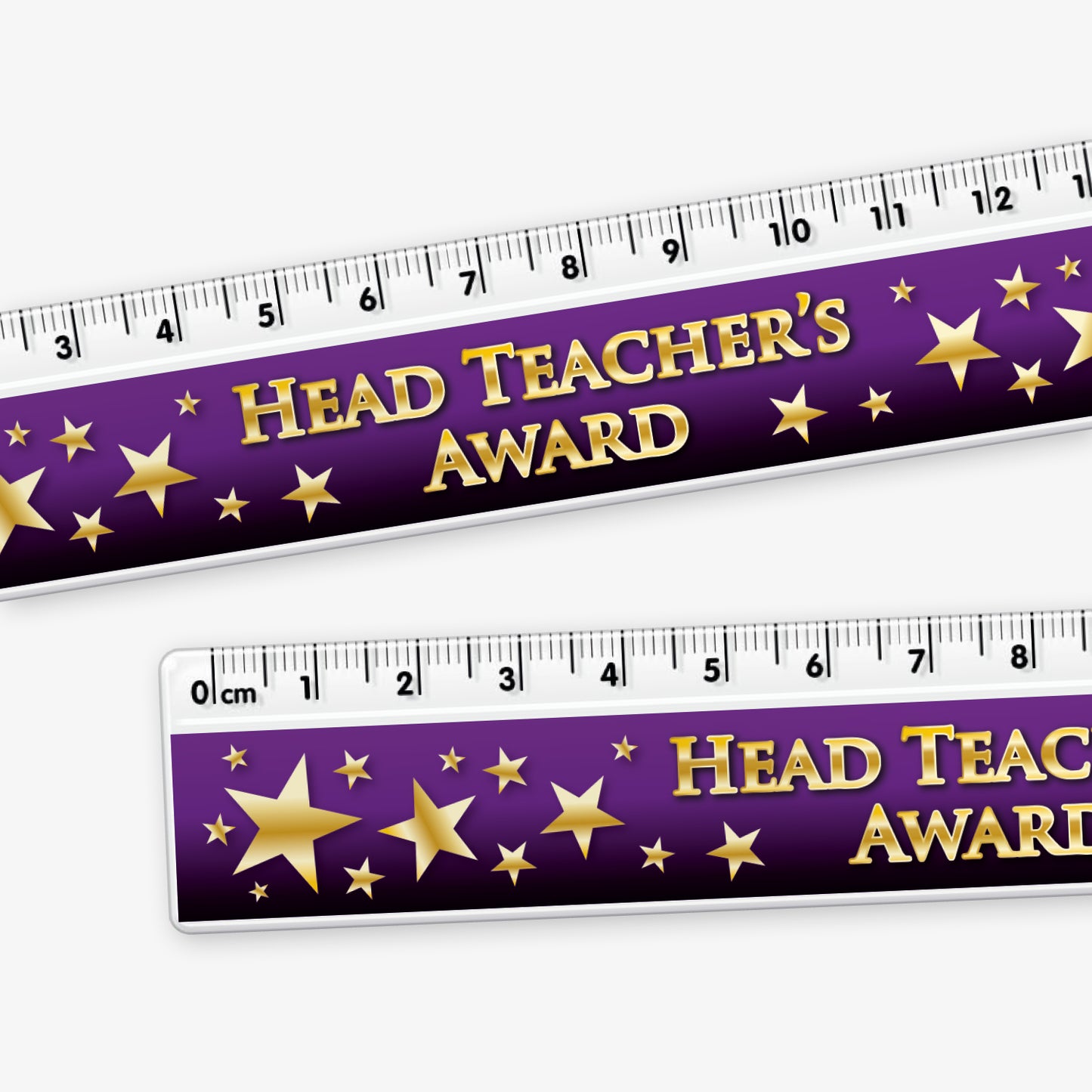 Close up of 15cm ruler featuring a dark purple background with gold stars; and bold gold text reading 'Head Teacher's Award' along the centre.
