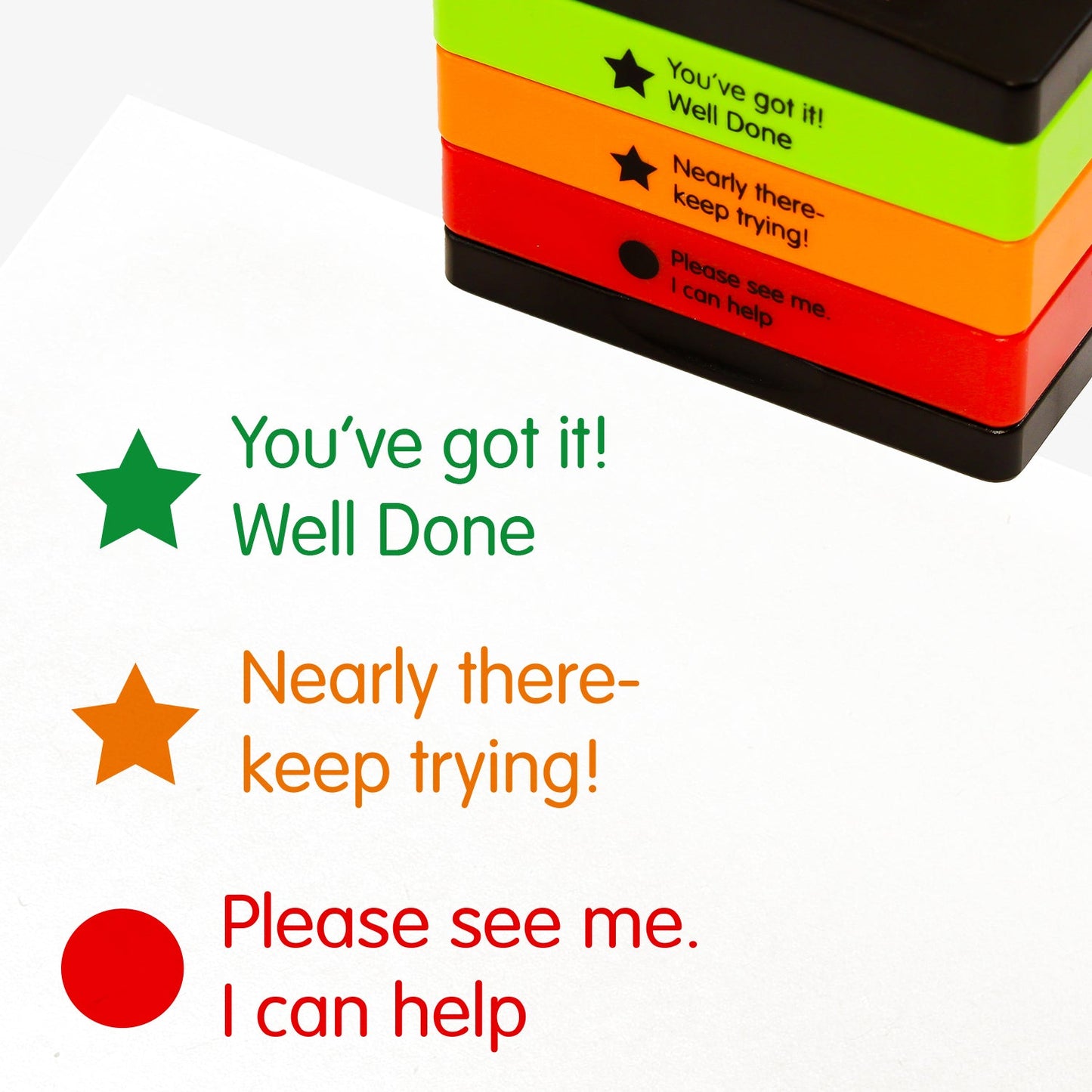 3 stacked rectangular self-inking stampers measuring 44mm by 13mm, featuring the imprint - 'You've got it! Well Done' in green ink with a green filled star; 'Nearly there - keep trying!' in orange ink with an orange filled star; 'Please see me. I can help' in red ink with a red filled circle.