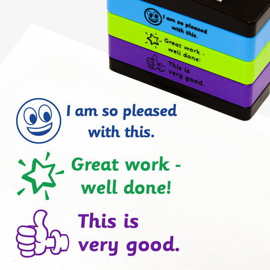 3 stacked rectangular self-inking stampers measuring 44mm by 13mm, featuring the imprint - 'I am so pleased with this' in blue ink with a blue smiling emoji to the left; 'Great work - well done!' in green ink with a shining green star to the left; 'This is very good.' in purple ink with a purple thumbs up icon.