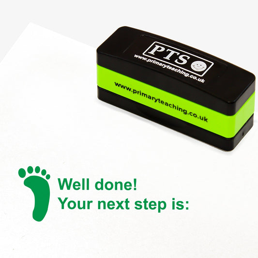 Rectangular self-inking stackable stamper 44mm x 13mm with green ink, displaying the text 'Well Done! Your next step is:' alongside the green footprint.