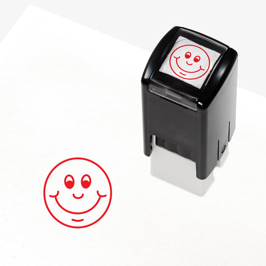 Red 10mm pre-inked stamper featuring a smiling cartoon emoji face