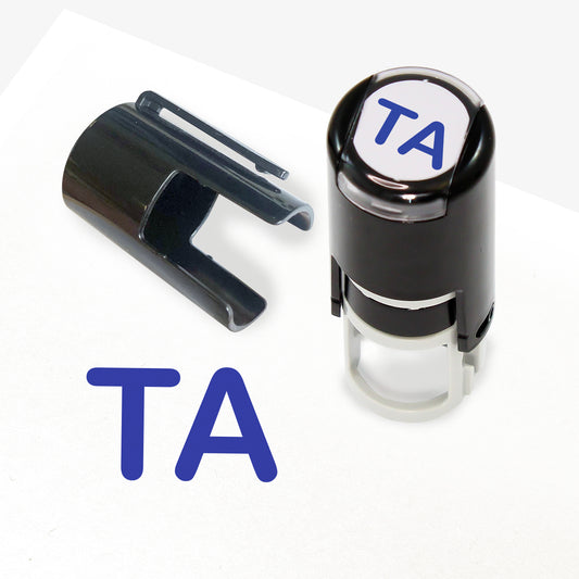 A 10mm self-inking stamp with blue letters 'TA' central to the design.  The stamper lid also shows a clip for attaching the stamper to a lanyard.