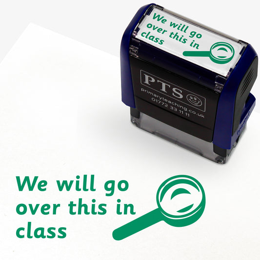 Rectangular self-inking stamper 38mm x 15mm with green ink, displaying the text 'We will go over this in class' alongside the outline of a magnifying glass.
