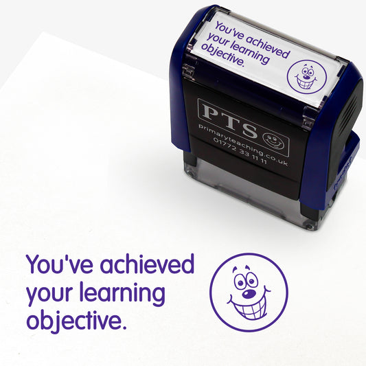 A rectangular self-inking stamper, displaying the purple text 'You've achieved your learning objective' alongside a smiling emoji face; stamper measures 38mm by 15mm