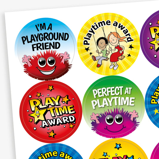 Sheet of colourful round reward stickers with phrases such as 'I'm a Playground Friend', 'Playtime Award', and 'Perfect at Playtime', featuring cheerful characters and vibrant backgrounds.