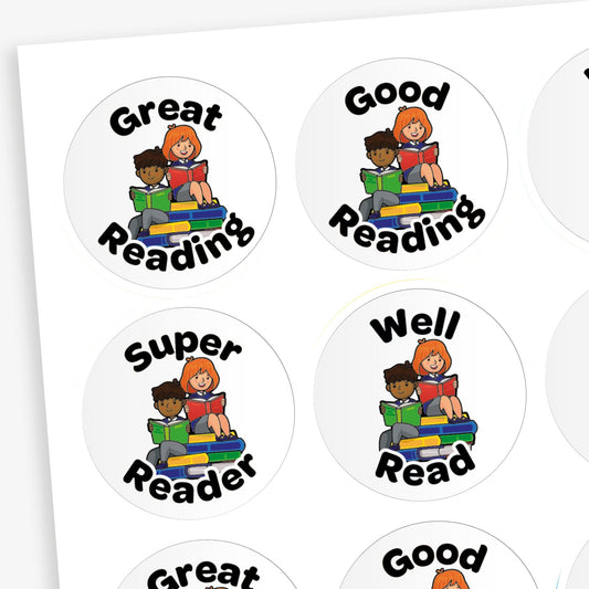 A sheet of round reading reward stickers. Each sticker features an illustration of two children—one with dark skin and short hair, the other with light skin and red hair—sitting on a stack of colourful books and reading. The stickers have various positive phrases in bold black letters such as 'Great Reading', 'Good Reading', 'Super Reader', and 'Well Read'.