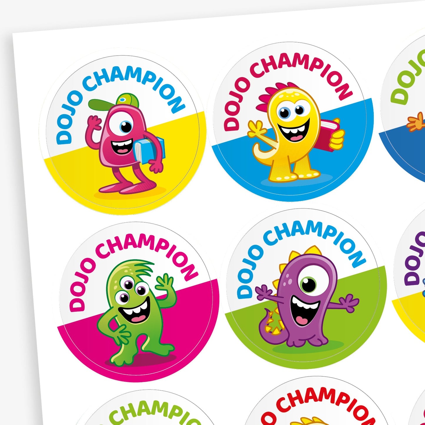 Sheet of 32mm circular stickers. Each has a colourful monster as a central image, the bottom half of the sticker is a block colour such as yellow, cyan, magenta or green and the top has the phrase 'DOJO CHAMPION'