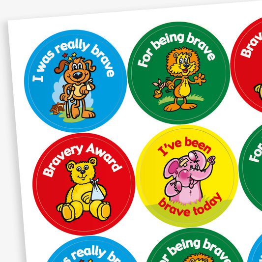 Sheet of vibrant circular stickers with cartoon characters such as a dog on crutches, and elephant with a plaster on it's head, a bear with it's arm in a sling and a lion with a bandage on it's tail; with phrases including 'I was really brave', 'For being brave'. 'Bravery Award' and 'I've been brave today'
