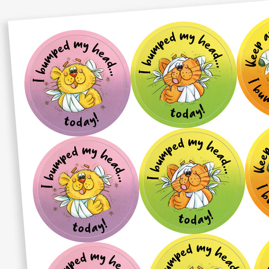 Sheet of pastel background stickers with a cat central to the image with a bandaged arm and head.  There is text surrounding the image saying 'I bumped my head…..today!'