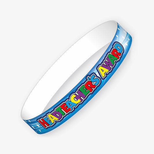 A set of ten pale blue wristbands featuring the phrase 'HEADTEACHER'S AWARD' in bold multi-coloured block letters, surrounded by white stars.