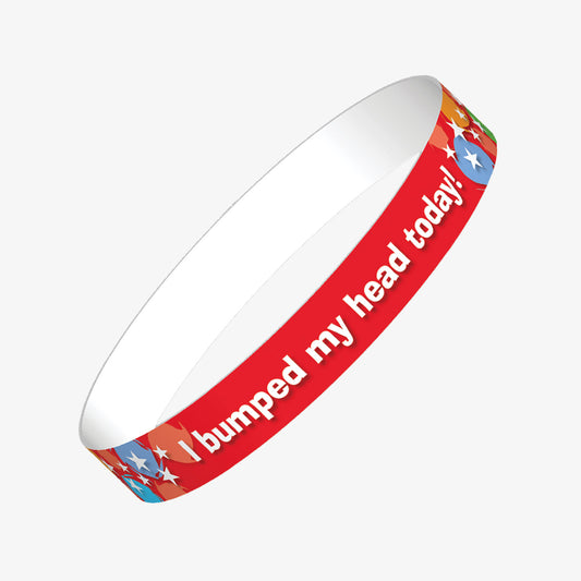A set of ten red wristbands featuring the phrase 'I bumped my head today' in bold white letters, with stars and multicoloured splats on the band; designed to alert staff and parents that a child has experienced a minor head bump during school hours.