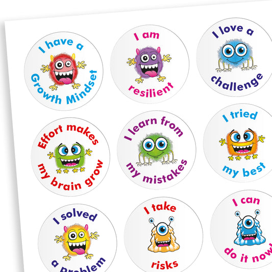 A jellybean scented sheet of circular growth mindset stickers featuring colourful cartoon monsters and motivational phrases. Phrases include: 'I have a Growth Mindset', 'I am resilient', 'I love a challenge', 'Effort makes my brain grow', 'I learn from my mistakes', 'I tried my best', 'I solved a problem', 'I take risks', and 'I can do it now'. Each sticker has a unique monster character and a different bright colour scheme.